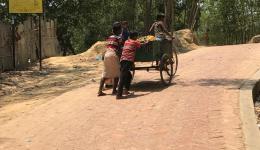 Children pushing a cart in the refugee camp of the Rohingya.