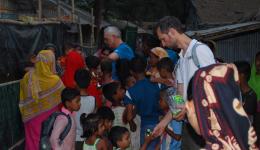 Alois and Michael distributing sweets to children in the slums.