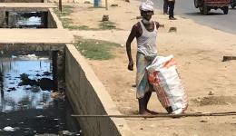 Bangladesh's population is also very poor. This man tried to recover recyclables out of the sewage with a stick.