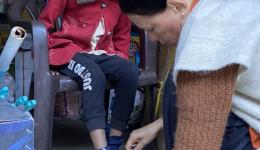 The morning before we leave, we buy shoes for the children of a widow.